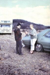 Irene "Granny" York, the owner of York Farm, the location of the Sound Storm music festival, leans on an automobile near two unidentified men, possibly festival staff. (Courtesy of Wisconsin Historical Society)