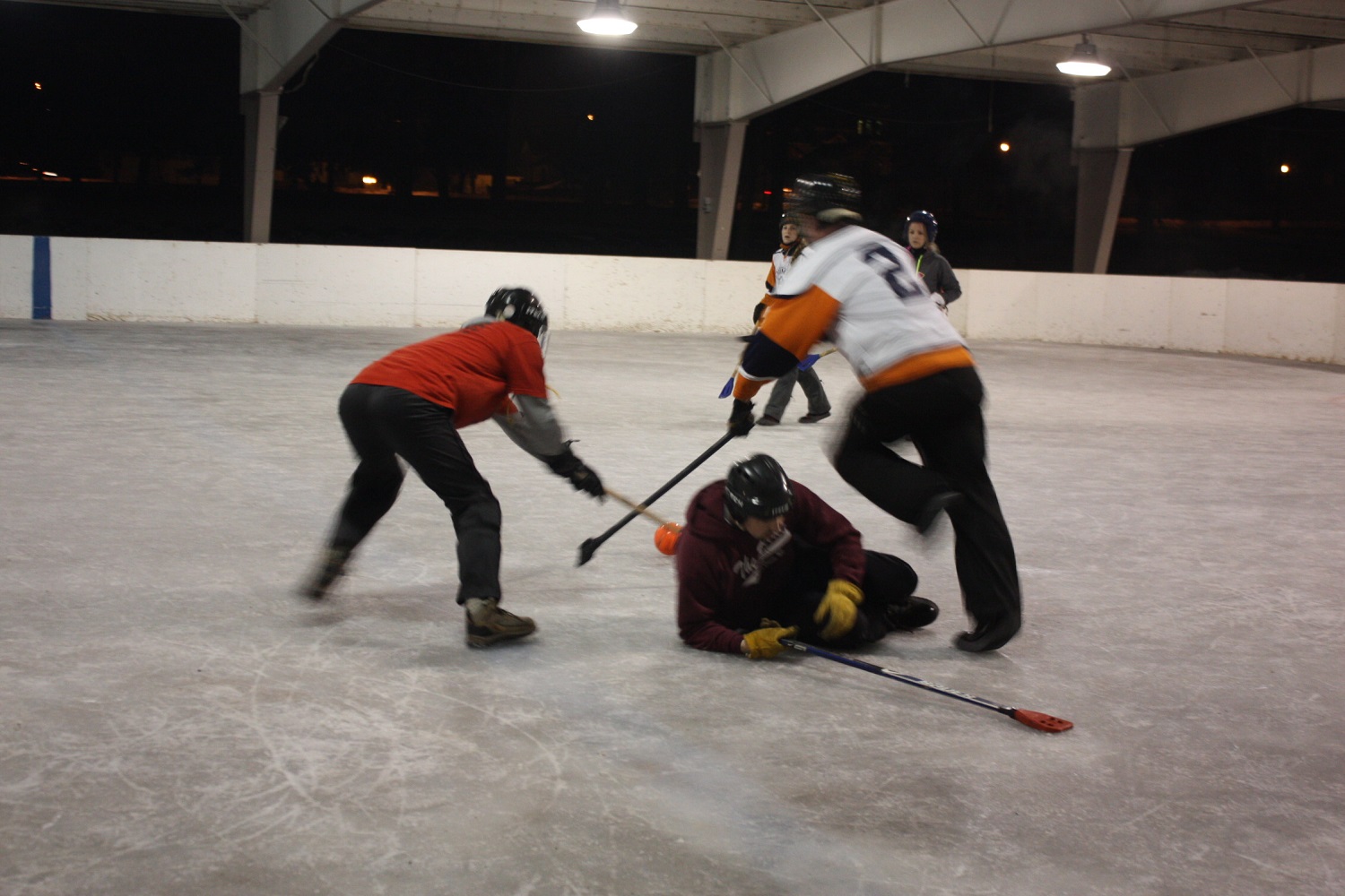 La Crosse broomball teams sponsored by Animal House and John's Bar play each other at the Copeland Park Oktoberfest Shelter in 2013. (Maureen McCollum/WPR)