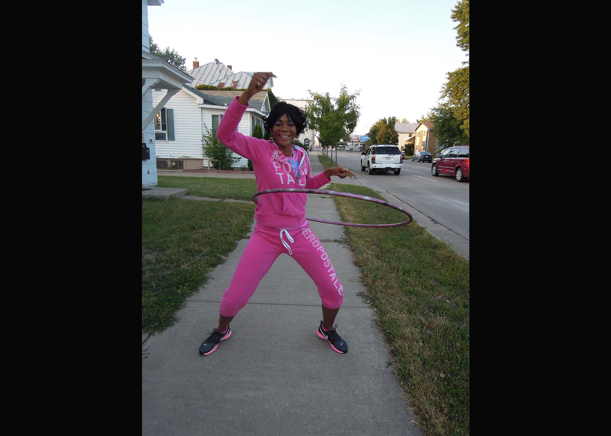 Brenda Jackson, better known as Peaches, hula hoops on the corner of 4th Street and Jackson Street in La Crosse, Wisconsin in 2013. (Maureen McCollum/WPR)
