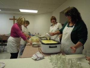 Christ Lutheran Church volunteers melting butter in 2013.