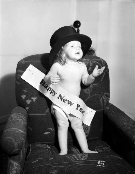 "Miss 1935," one-year-old Lois Ann Endres standing in an overstuffed chair wearing a top hat and Happy New Year banner. (Courtesy of