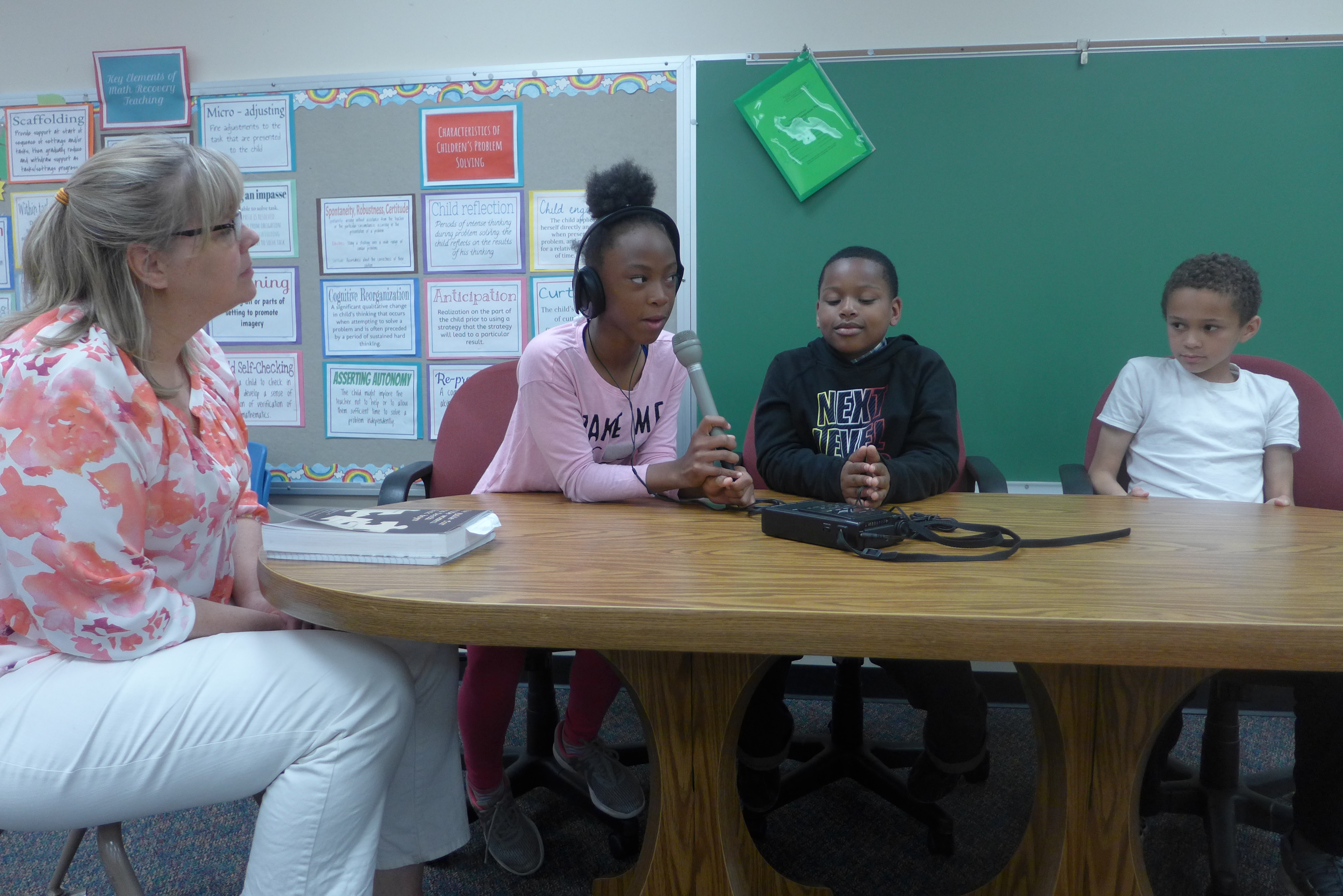 Chegwin Elementary School fourth grade teacher Pam Yanagihashi talks with her students Jakyla Smith, Nolen Henigan, and Sam Tynan