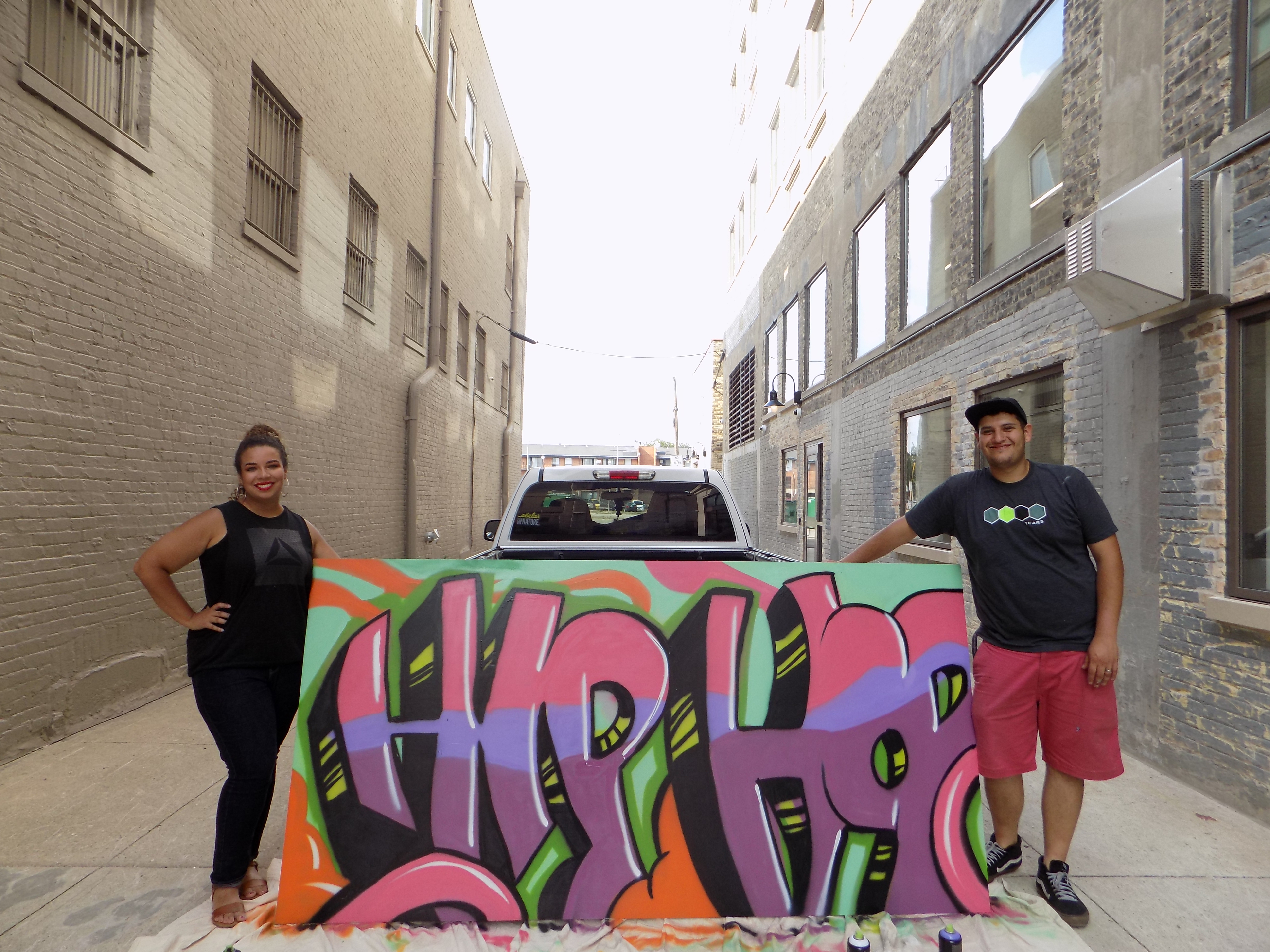 Taylor Herrada and Charlie Herrada, of the H2 Collaborative, create an art piece for Hip-Hop Week.
