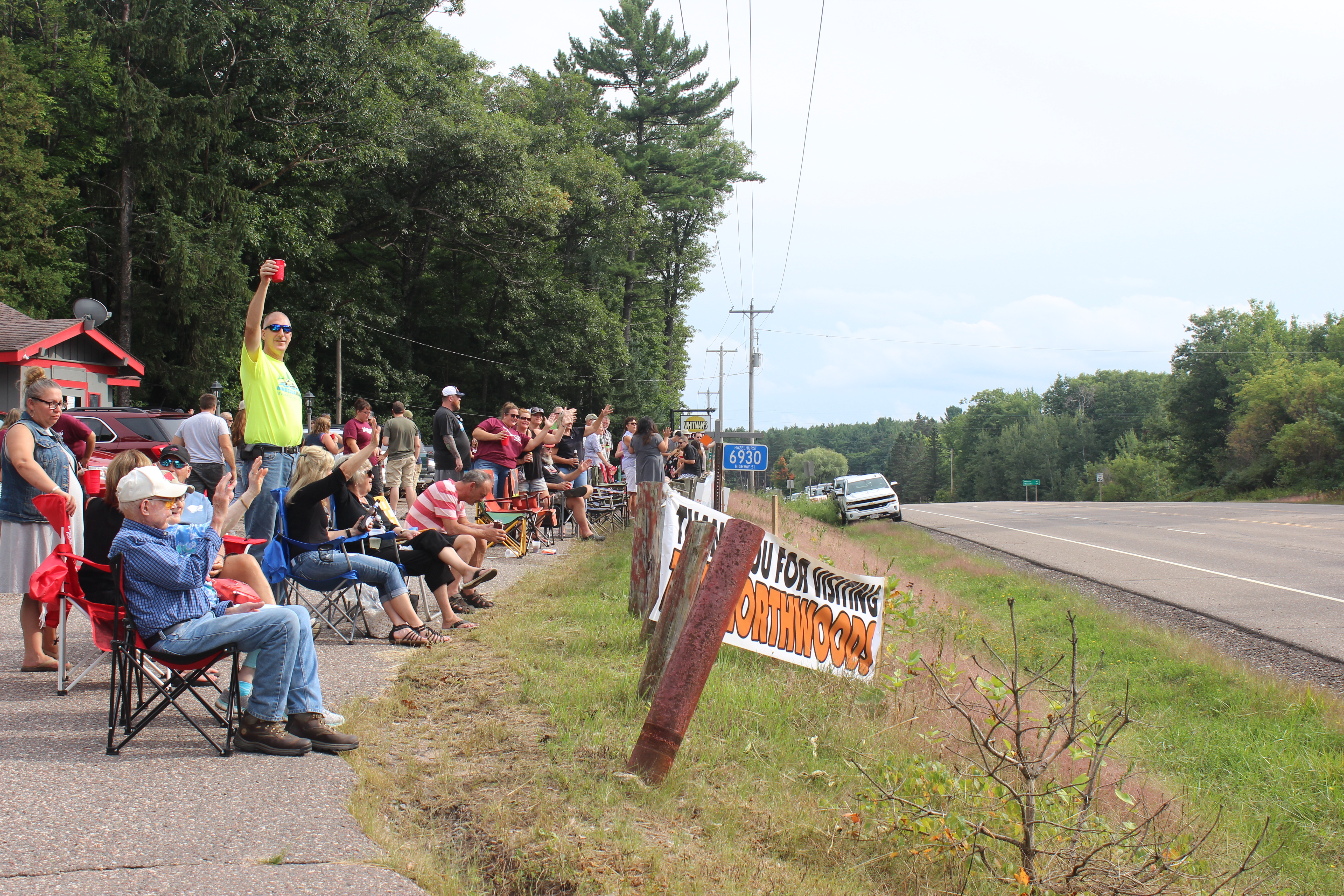 People wave good-bye to tourists at Whitman's Bar & Grill in Hazelhurst, WI.