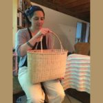 April Stone with one of her black ash baskets. (Photo by Tressa Versteeg)