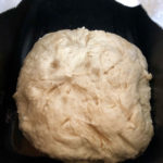 Frybread dough rests in a black bowl