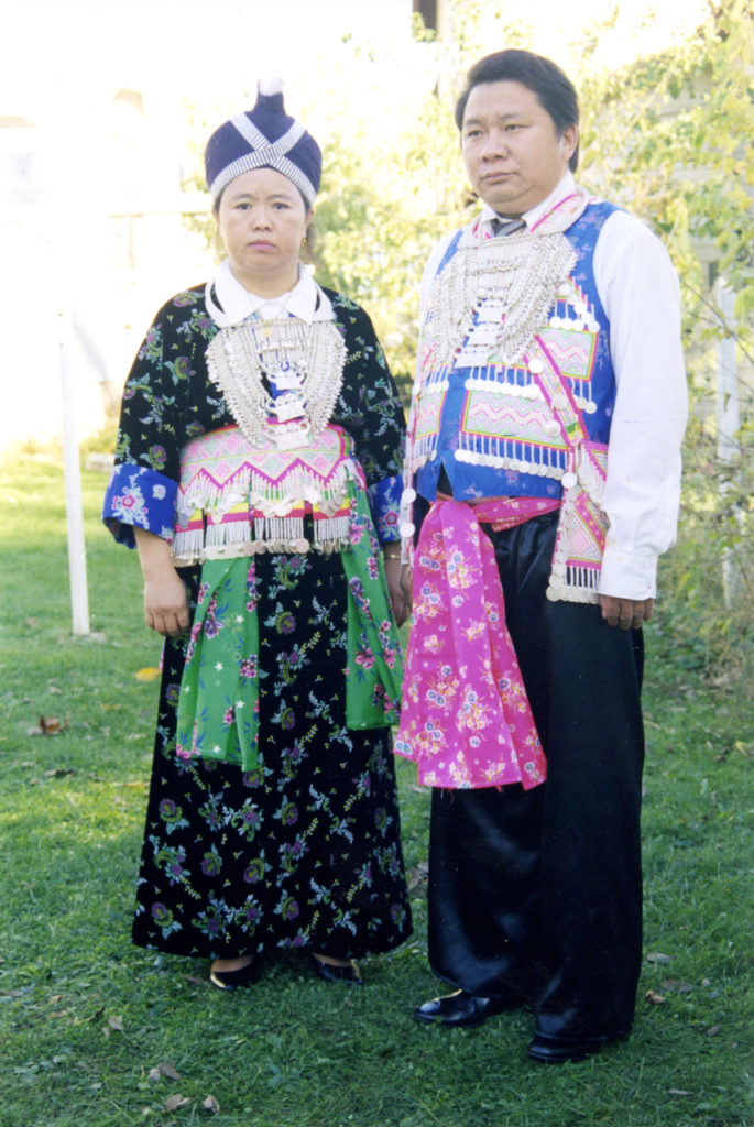 Lucy's mother and father wear traditional Hmong embroidered textiles and silver necklaces