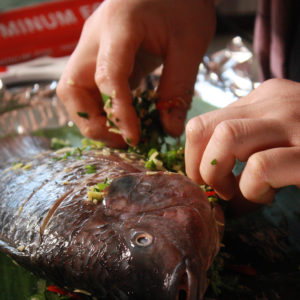 Stuffing herbs and spices into the whole fish