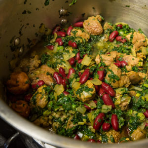 Chicken, herbs and kidney beans simmer in the pot