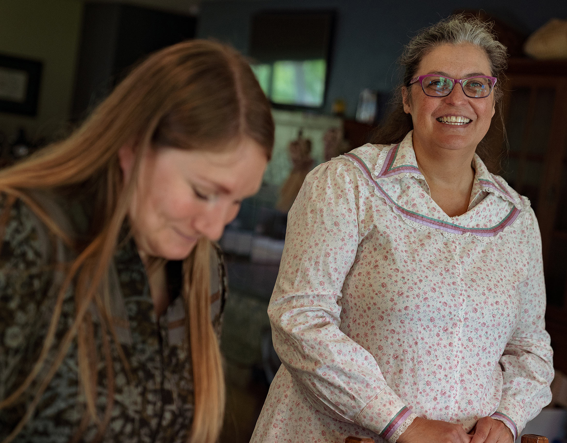 Rebecca and Laura laugh and smile as they cook together