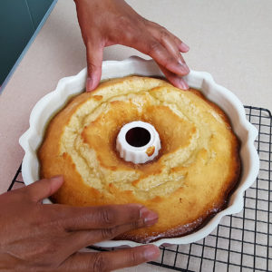 Monica prepares to flip the cake on to the cooling rack