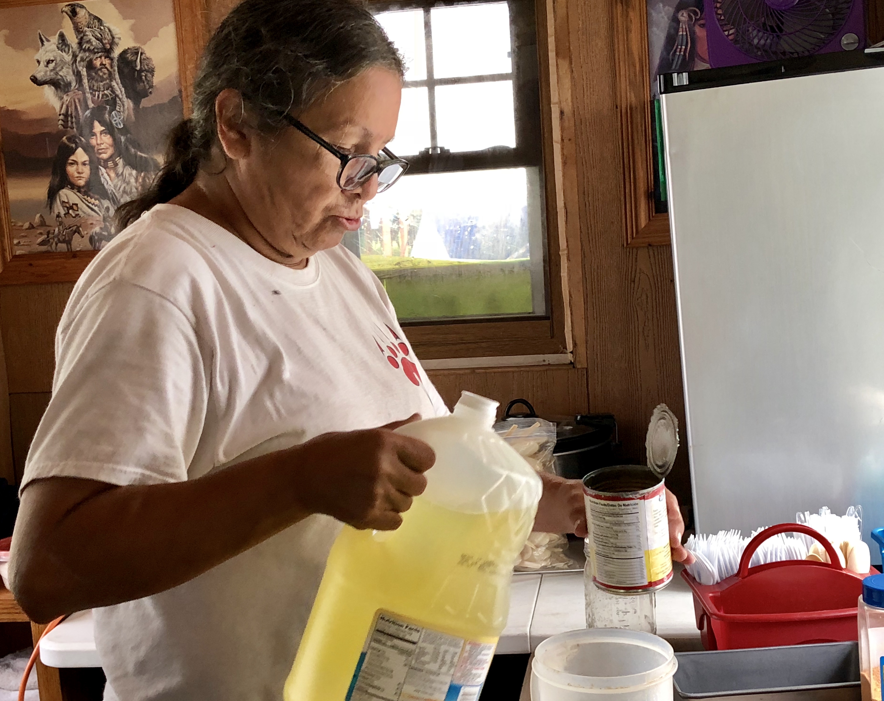 Katherine Denomie mixes the ingredients for frybread dough in her kitchen.