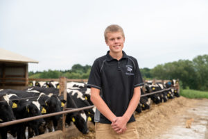 Fourteen year-old Drew Dettmann at Dettmann Dairy Farms in Johnson Creek, Wisconsin. (Photo by Max Cozzi for The Lands We Share)