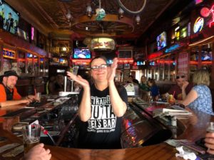 Sara Viner dances to the jukebox while working at Del's Bar in downtown La Crosse. (Maureen McCollum/WPR)