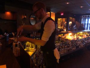 A look at all the bottles behind the bar at Bryant's as bartender Dave Cornils mixes drinks. (Maureen McCollum/WPR)