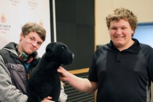 MG21 students Ashton Botts, left, and Preston Ivey with the WPR stuffed dog on a field trip to the station. (Jenny Peek/WPR)