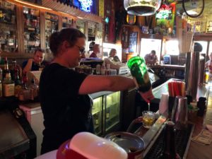 Sara Viner makes a cocktail at Del's Bar. (Maureen McCollum/WPR)