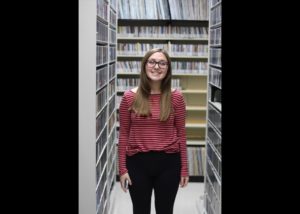 MG21 student Abbie Pochel in WPR's music library during a field trip. (Jenny Peek/WPR)