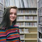 MG21 student Circe Johnson in WPR's music library during a field trip. (Jenny Peek/WPR)