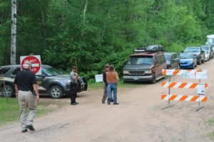Law enforcement monitor the exit and control traffic on Canthook Lake Road, which leads in and out of the Rainbow Family gathering. (Danielle Kaeding/WPR)