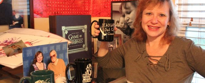 GinGee Girls owner and artist Sunshine Levy shows off a mug she sandblasted alongside memorabilia from comic cons. (Photo by Victoria Davis)