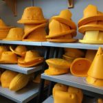 Cheesehead fedoras, cowboy and party hats, and firefighter helmets on display at Foamation's factory store in Milwaukee. (Maureen McCollum/WPR)