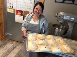 Joe's Pasty Shop owner Jessica Lapachin with a tray of pasties. (Jane Genske/WPR)