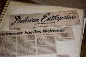 A family album holds a newspaper clipping.