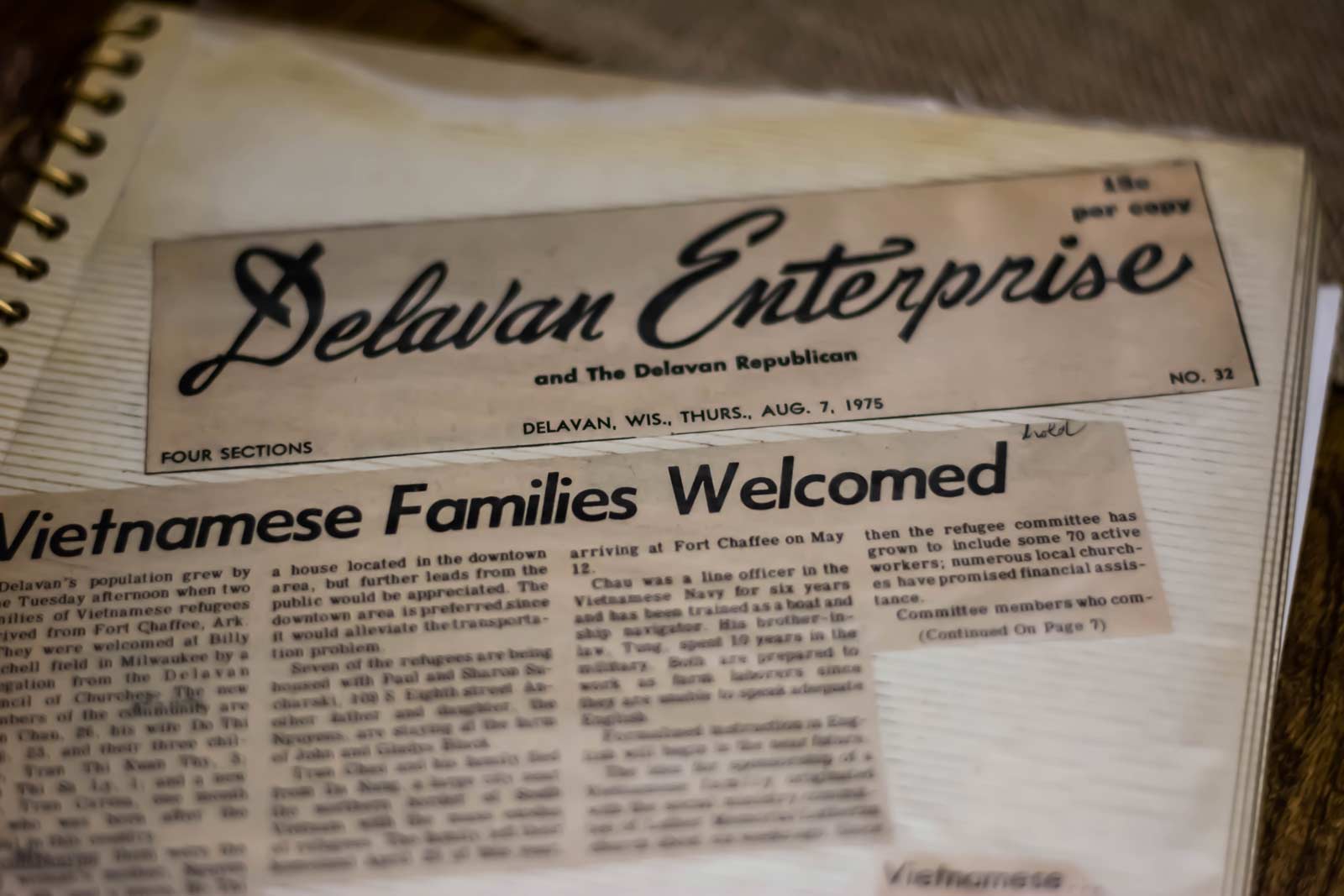 A family album holds a newspaper clipping.