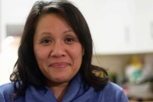 Carina Tran stands for a portrait in her kitchen.