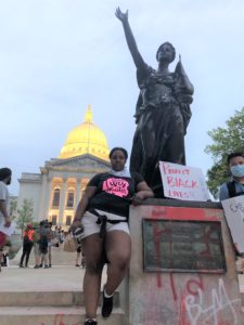 Ebony Anderson-Carter next to the Forward Statue in Madison. (Maureen McCollum/WPR)
