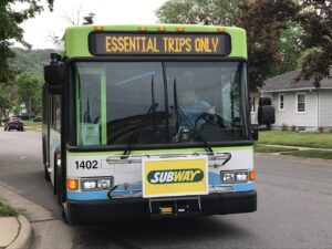 A sign on a La Crosse bus promotes "essential trips only" during the first couple of months of the coronavirus pandemic. Trip restrictions have now loosened for bus systems around Wisconsin. (Kathy Davis/WPR)
