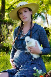 Mother-to-be Destiny Skubis and Disco the chicken at Lovelight Flowers Farm. (Courtesy of Destiny Skubis)