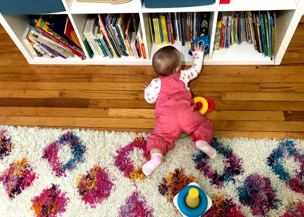 Magnolia Grube reaches for a toy in her bedroom at her home in Janesville, Wis. in February 2021. (Andrea Anderson/WPR)