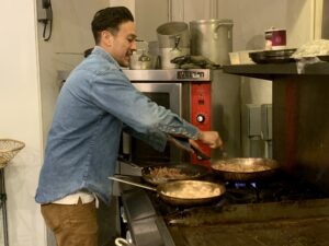 Sam Luna cooks for the musicians, artists and visitors at The Heist. (Photo by Ayisha Jaffer)