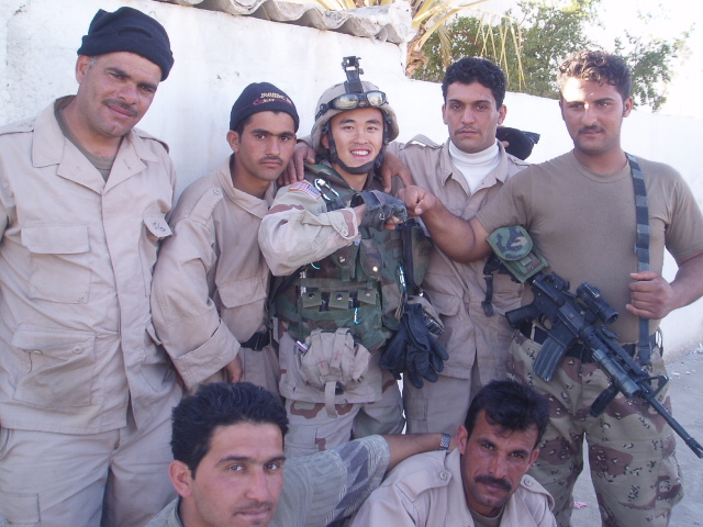 Yauo Yang (center) with a group of Iraqi soldiers that the U.S. Army Reserve would train to do security missions. (Courtesy of Yauo Yang)