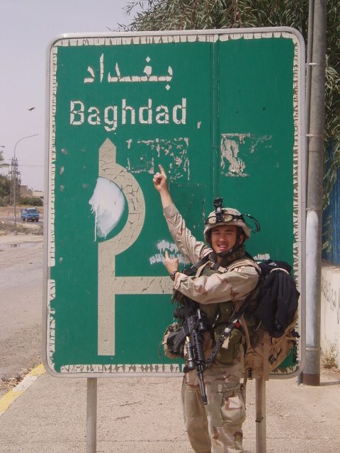 Yauo Yang with an Iraqi traffic sign in Samarra, which is 1.5 hours north of Baghdad. (Courtesy of Yauo Yang)