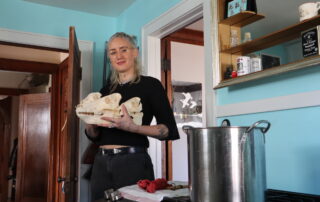 Lisa Lauren, the owner, artist and silversmith of Kettle Black Silver Co., holds three animal skulls she processed. (Steven Potter/WPR)