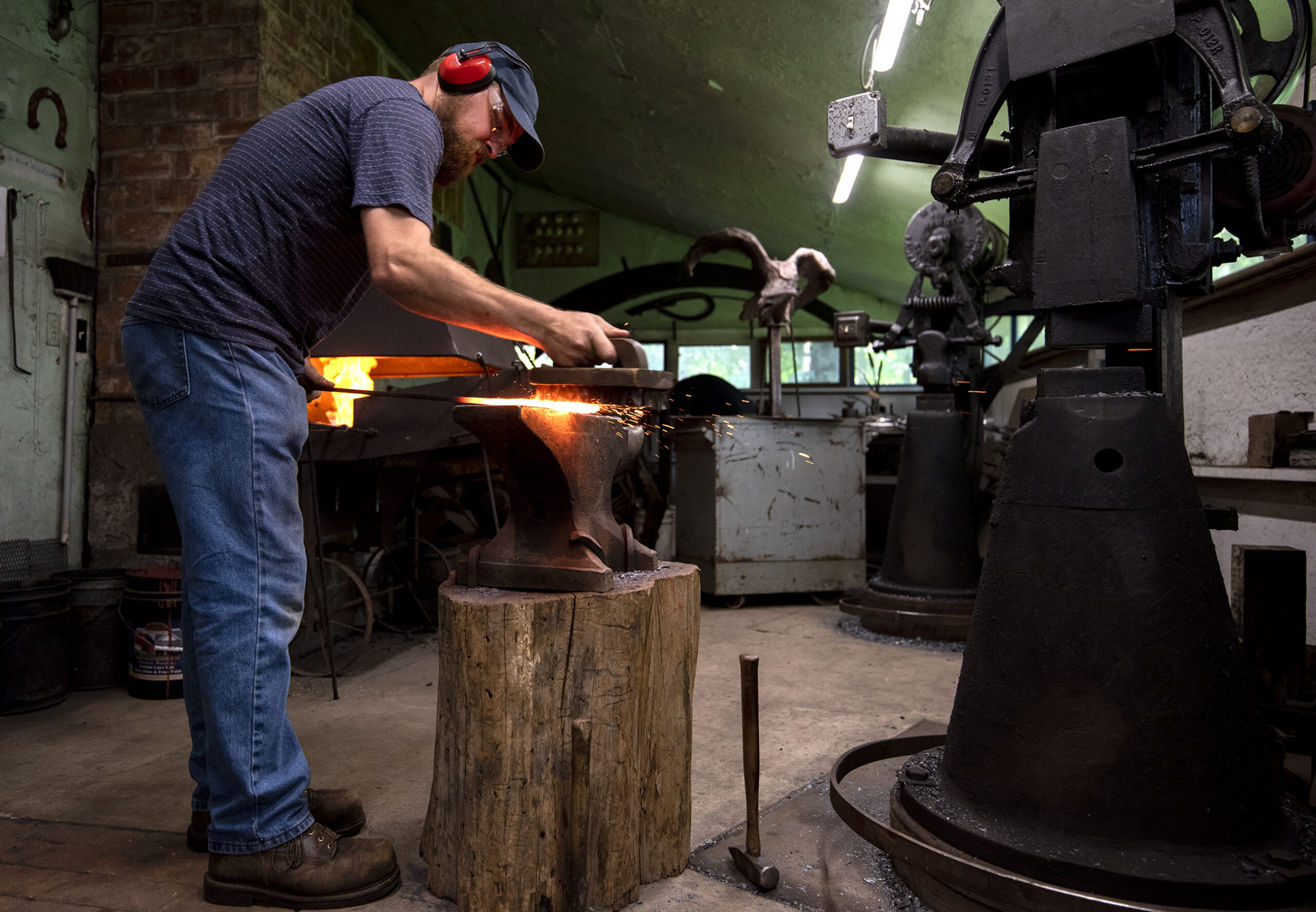 Vincent Kochanowski works with hot metal at the studio Tuesday, June 29, 2021, in Junction City, Wis.