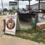 In this photo taken in July 2021 in La Crosse, Wis., a typical set up advertising a Chicken Q event can be seen. It's the scent of grilled chicken that helps bring customers in.