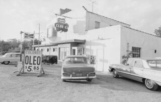 A car with Wisconsin license plates bearing the state's "America's Dairyland" slogan is parked just across the state line in Illinois at one of many impromptu dealers offering colored oleomargarine-illegal in Wisconsin for more than two decades--at bargain prices in case lots, September 15,1966. (AP Photo/Paul Shane)