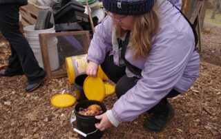 Nina Hartwig collecting compost for UW-Milwaukee's Panther Pails