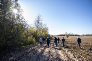 The group passes through a corn field after their journey to find the oldest tree in the state Sunday, Oct. 17, 2021, in Greenleaf, Wis.
