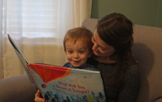 Jenny Peek reads to her two-year-old son Liam.