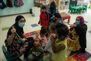 Iqra Sagged, a head teacher at Crescent Learning Center, reads “My First Ramadan” by Karen Katz to her students.