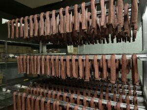 Landjaeger drying on racks at Bavaria Sausage in Madison (Brad Kolberg/WPR)