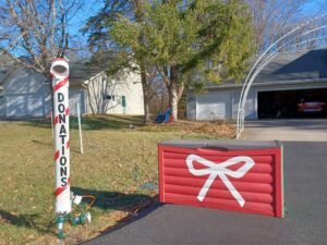 Those visiting Brody's Christmas Lights for Charity use this super-sized candy cane near the gift box to deposit monetary donations, which benefits the Oshkosh Kids Foundation. (Courtesy of the Enli family)