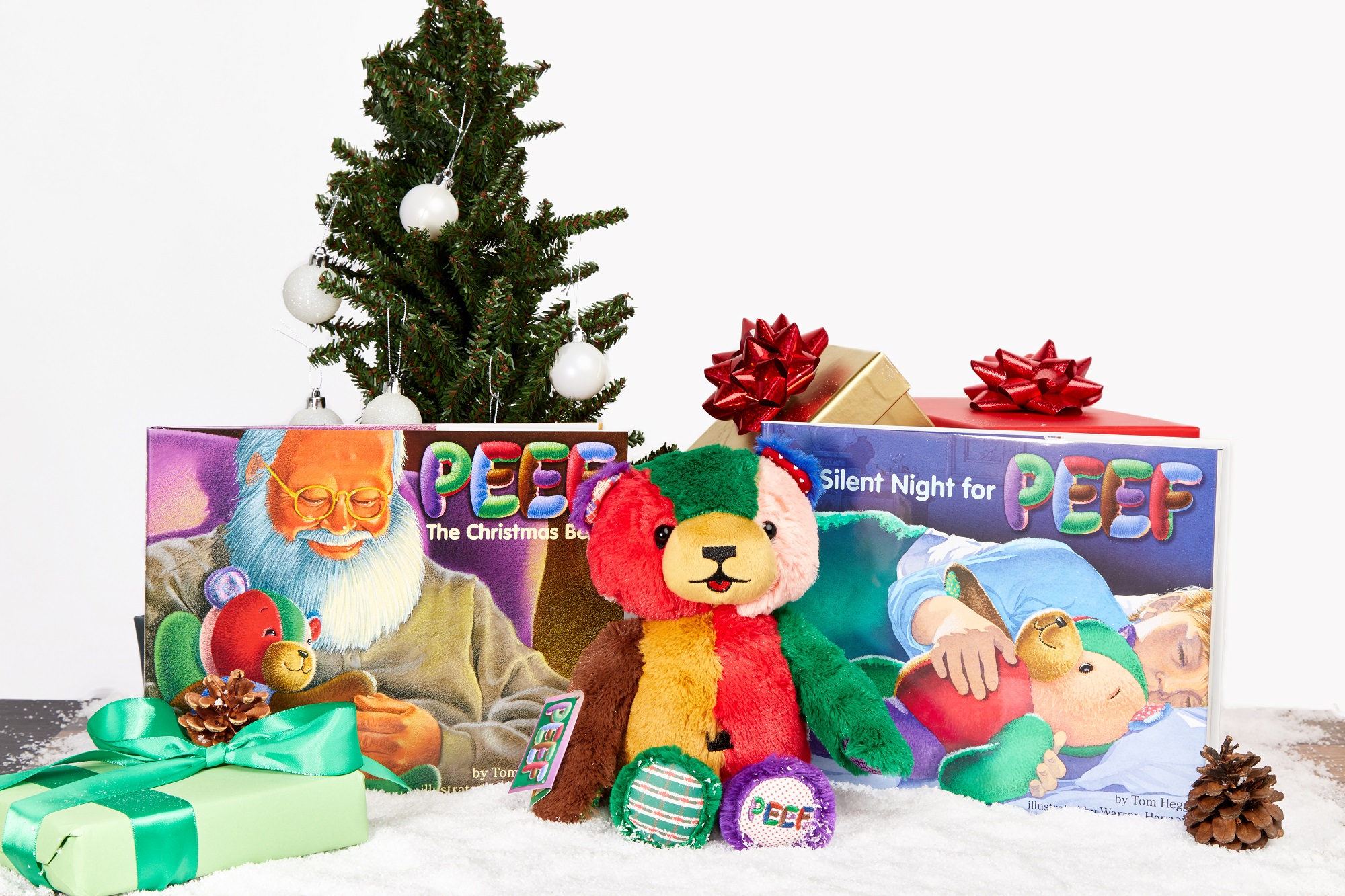 PEEF the bear alongside two of the Christmas books in his series by author Tom Hegg. (Courtesy of Tristan Publishing)