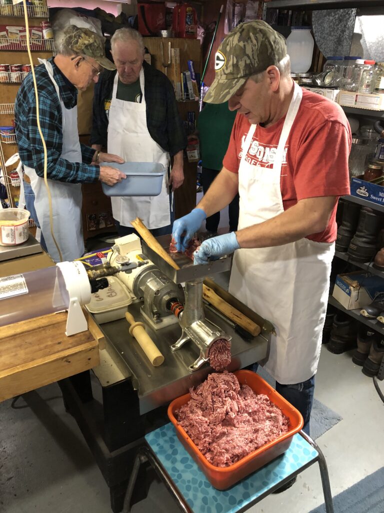 (left to right) Bob Schwartz, Bob Jahnke, and Scott Jahnke making sausage. (Photo by Briana Rupel)