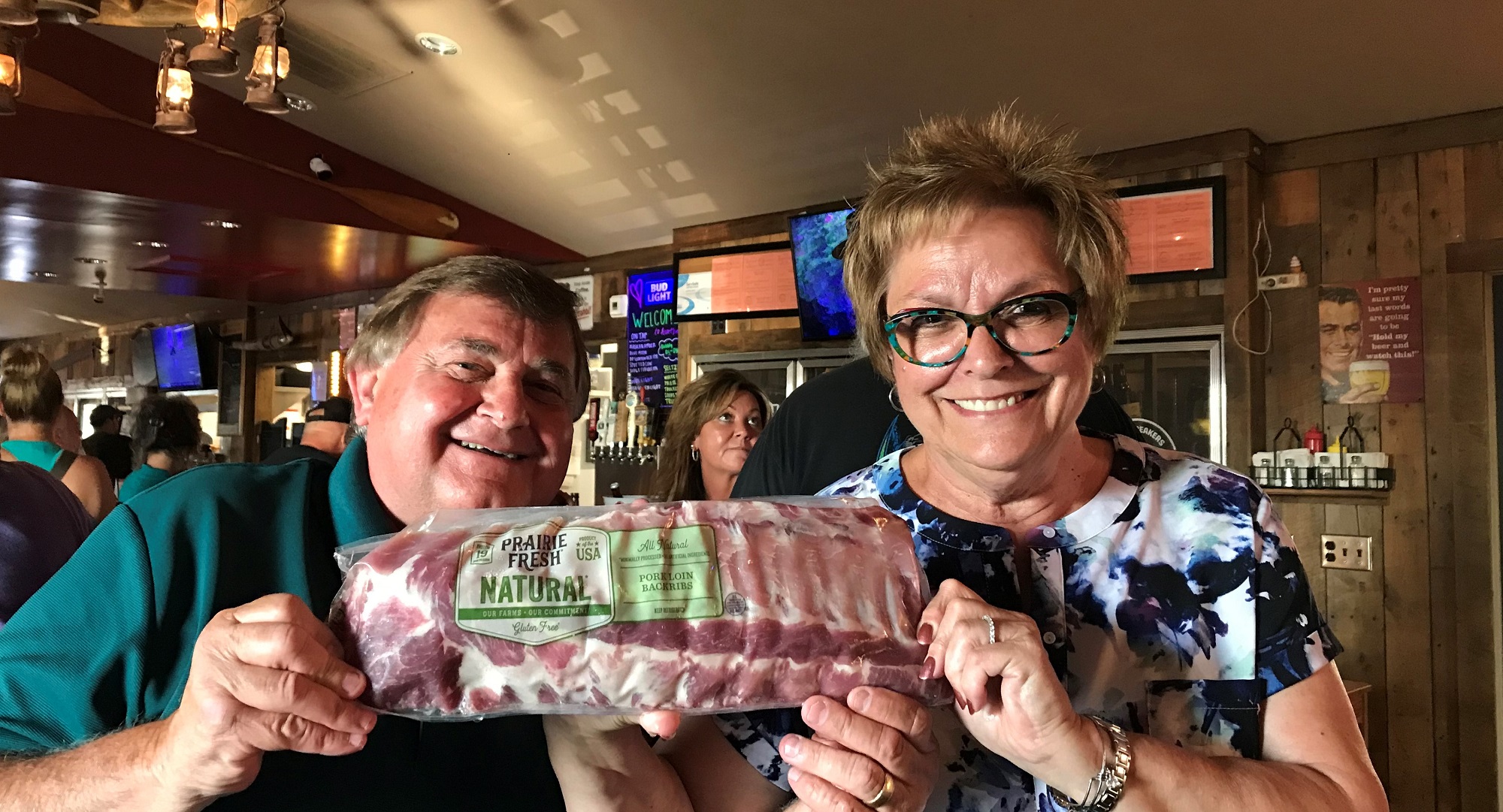 Bob and Connie Schroedel show off their meat raffle winnings at Heartbreakers in Lake Hallie, Wisconsin. (Courtesy of Patti See)